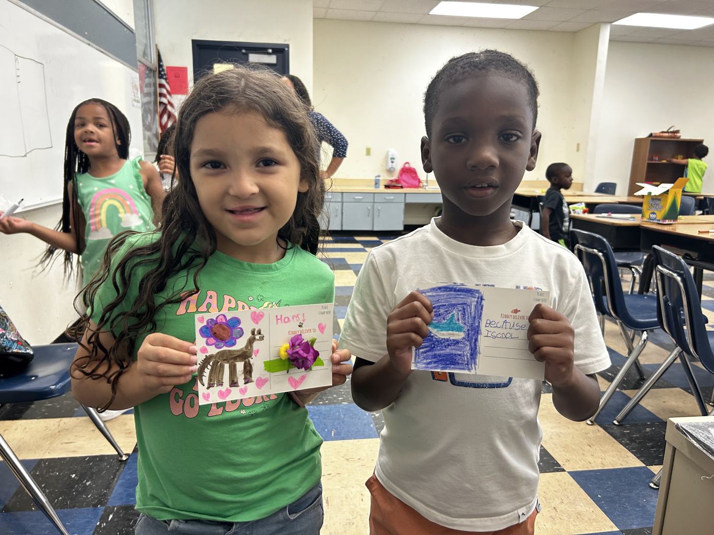 Two students showing their decorated cards