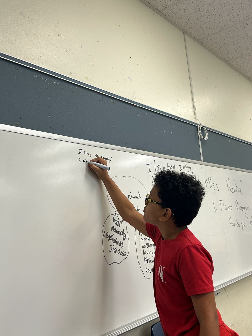 A student writing on the whiteboard